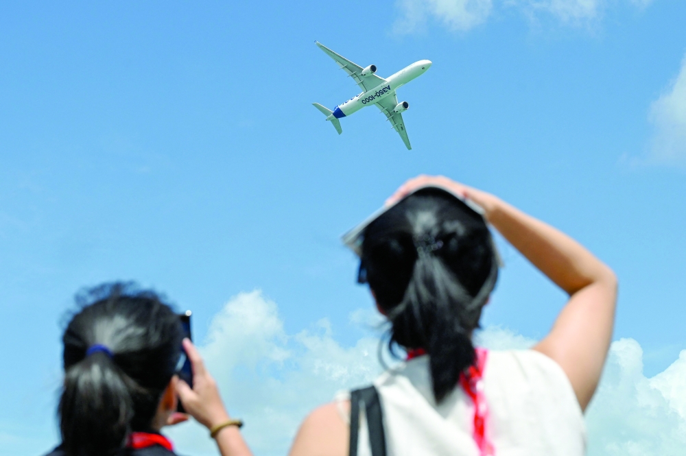 An Airbus' A350-1000 airliner takes part in an aerial display at the Singapore Airshow in Singapore. — AFP