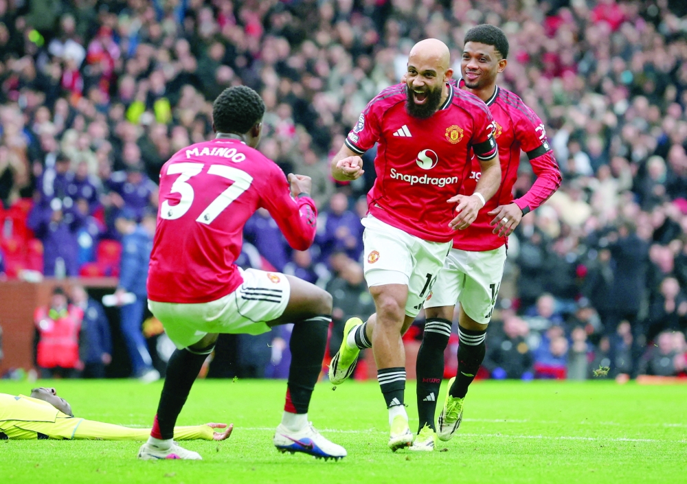 Manchester United's Bryan Mbeumo celebrates scoring their first goal with Manchester United's Amad Diallo and Manchester United's Kobbie Mainoo. — Reuters