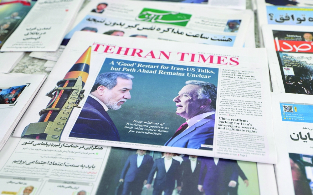A photograph shows copies of Iranian daily newspapers at a kiosk in Tehran on Saturday reporting on the first round of talks between Iran and the United States. — AFP