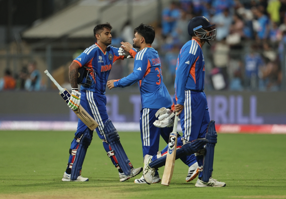   India's Rinku Singh with Varun Chakravarthy and Suryakumar Yadav at the end of the innings  