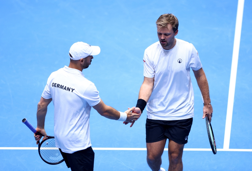   Germany's Kevin Krawietz and Tim Puetz react during their doubles match against Peru's Ignacio Buse and Arklon Huertas del Pino  