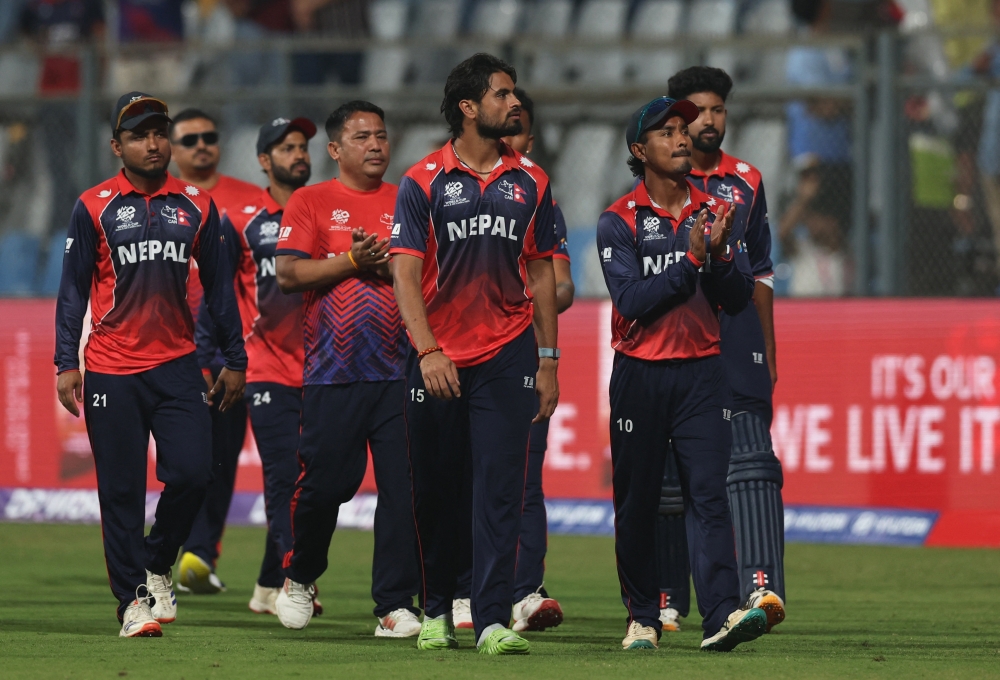 Nepal players look dejected as they applaud fans after losing the match  