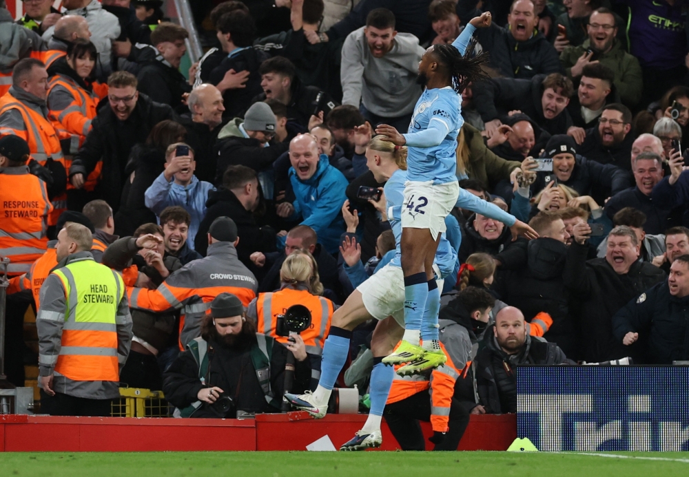   Manchester City's Erling Haaland celebrates with Antoine Semenyo  
