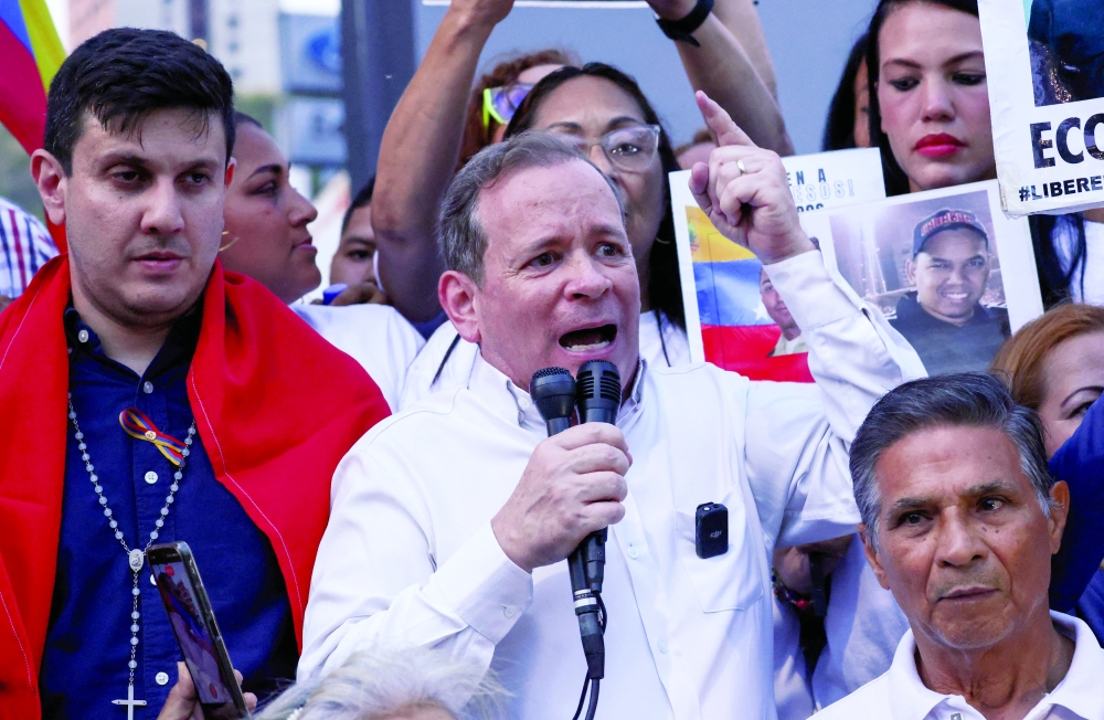 Venezuelan opposition politician Juan Pablo Guanipa greet relatives outside the Helicoide detention center, in Caracas. — Reuters