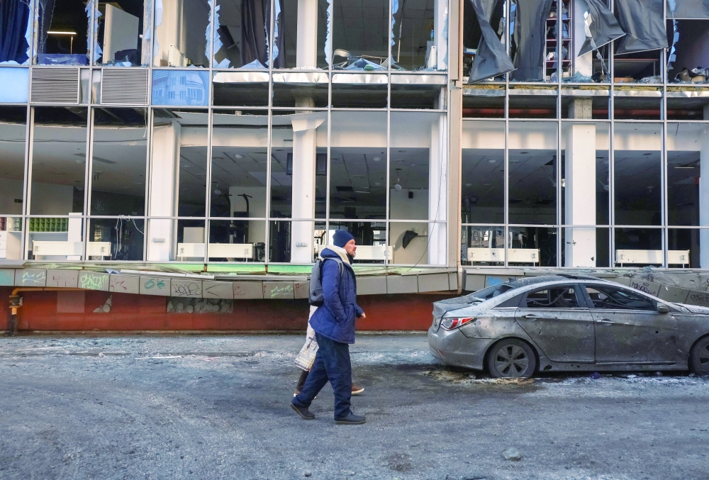 A resident walks near a building hit by a Russian drone strike, in Odesa. — Reuters