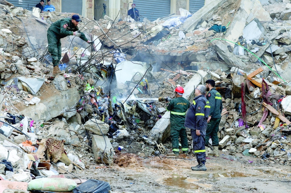 Rescue teams work at the site where a residential building collapsed in Tripoli. — Reuters
