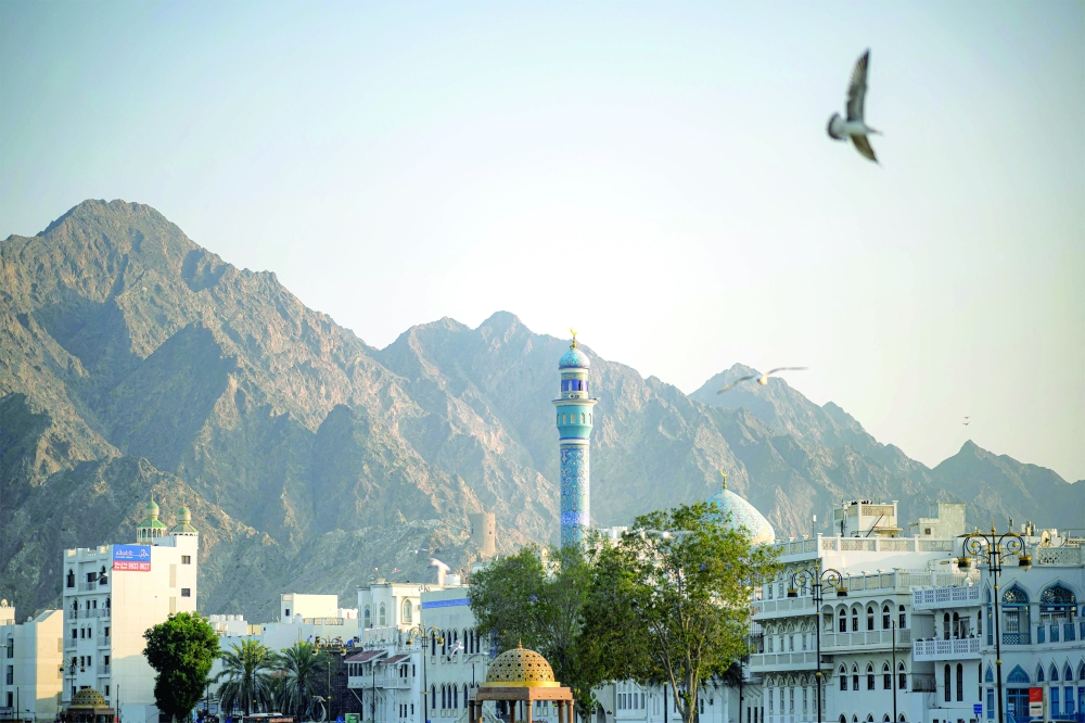 Seagulls fly near the Rasool al Adam mosque at the corniche of Sultan Qaboos port in Muscat. - AFP