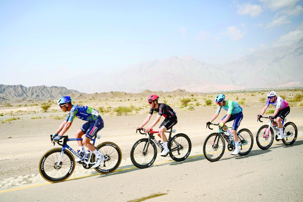 The pack rides during the 3rd stage of the Tour of Oman cycling race from Samayil "Al Fayhaa Resthouse" to Misfat Al Abriyeen, on February 9, 2026.  (Photo by Loic VENANCE / AFP)