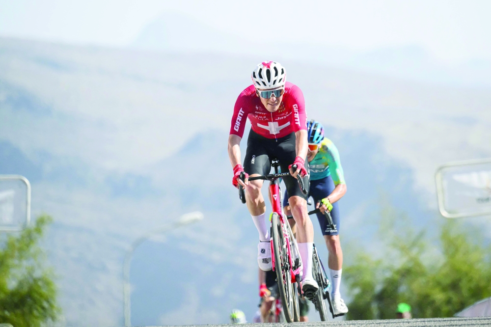 Team Jayco AlUla Swiss rider Mauro Schmid crosses the finish line to win the 3d stage of the Tour of Oman cycling race from Samayil "Al Fayhaa Resthouse" to Misfat Al Abriyeen, on February 9, 2026. (Photo by Loic VENANCE / AFP)