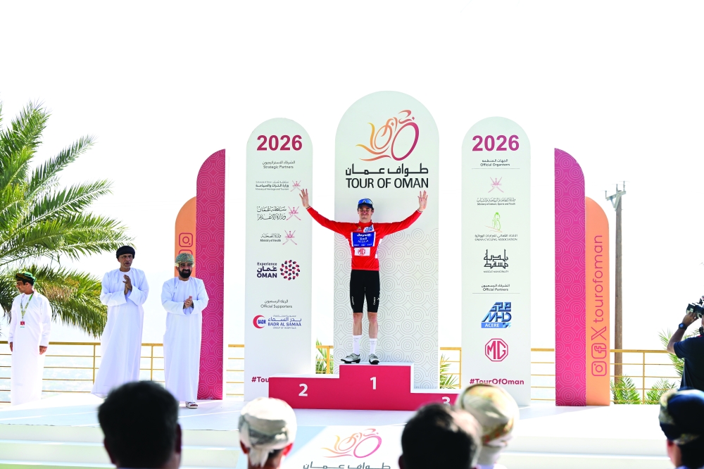 Team Jayco AlUla Swiss rider Mauro Schmid celebrates on the podium after winning the 3rd stage of the Tour of Oman. 
