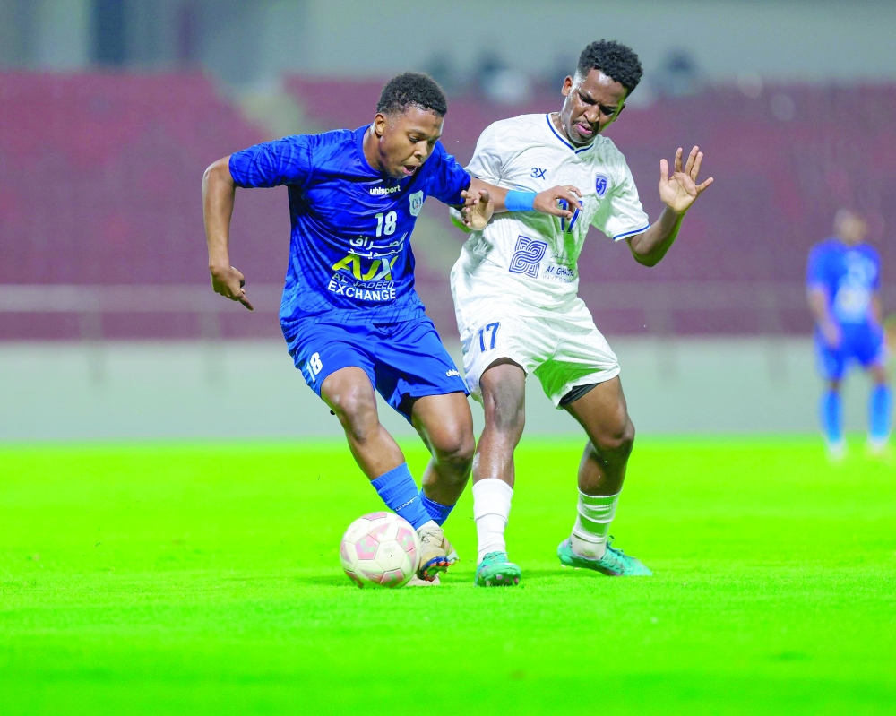 Al Nasr and Saham players in action.