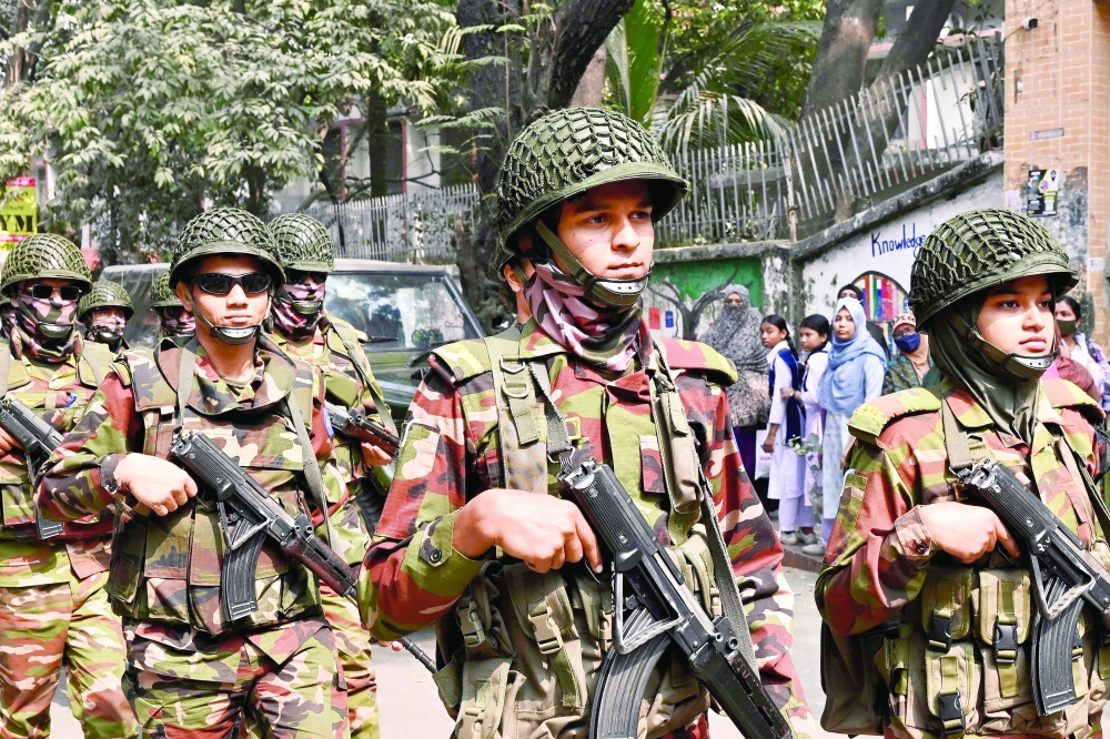 Bangladesh Army personnel patrol outside a polling station in Dhaka. — AFP