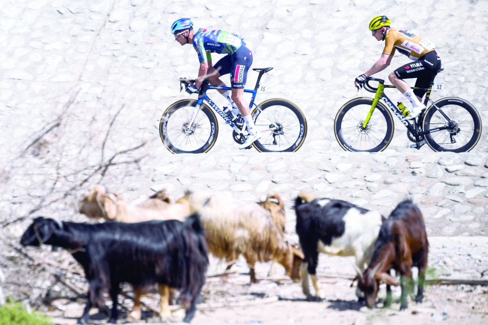Cyclists break away during the 4th stage of the Tour of Oman cycling race from Al Sawadi to Sohar, on February 10, 2026. (Photo by Loic VENANCE / AFP)
