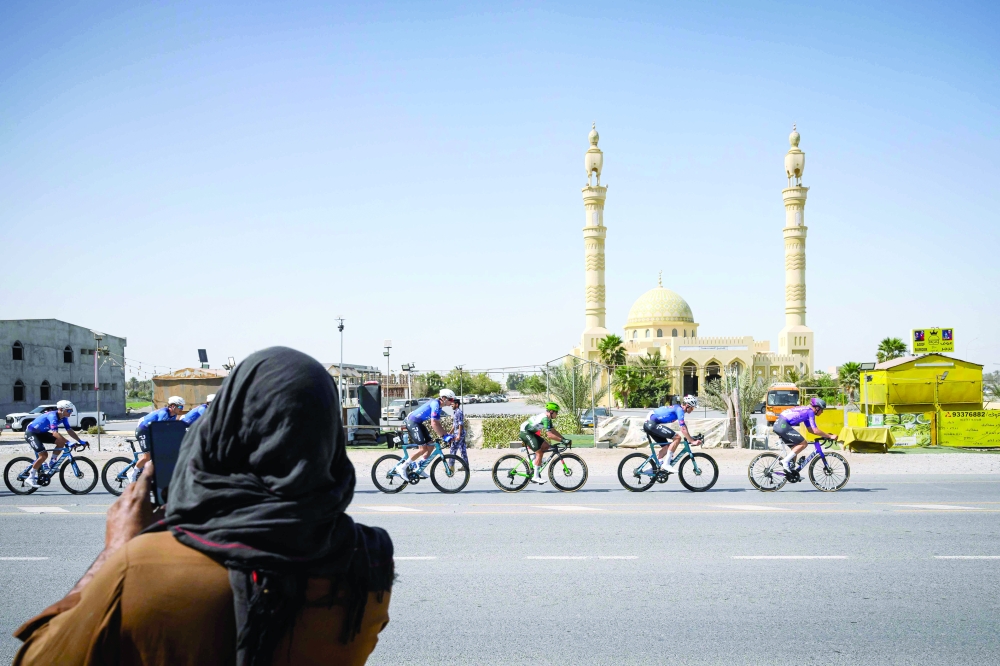 The pack rides during the 4th stage of the Tour of Oman cycling race from Al Sawadi to Sohar, on February 10, 2026. (Photo by Loic VENANCE / AFP)
