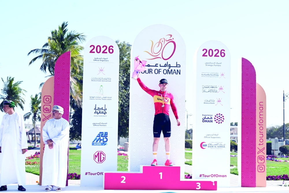 Uno-X Mobility Norvegian rider Erlend Blikra celebrates on the podium after winning the 4th stage of the Tour of Oman.