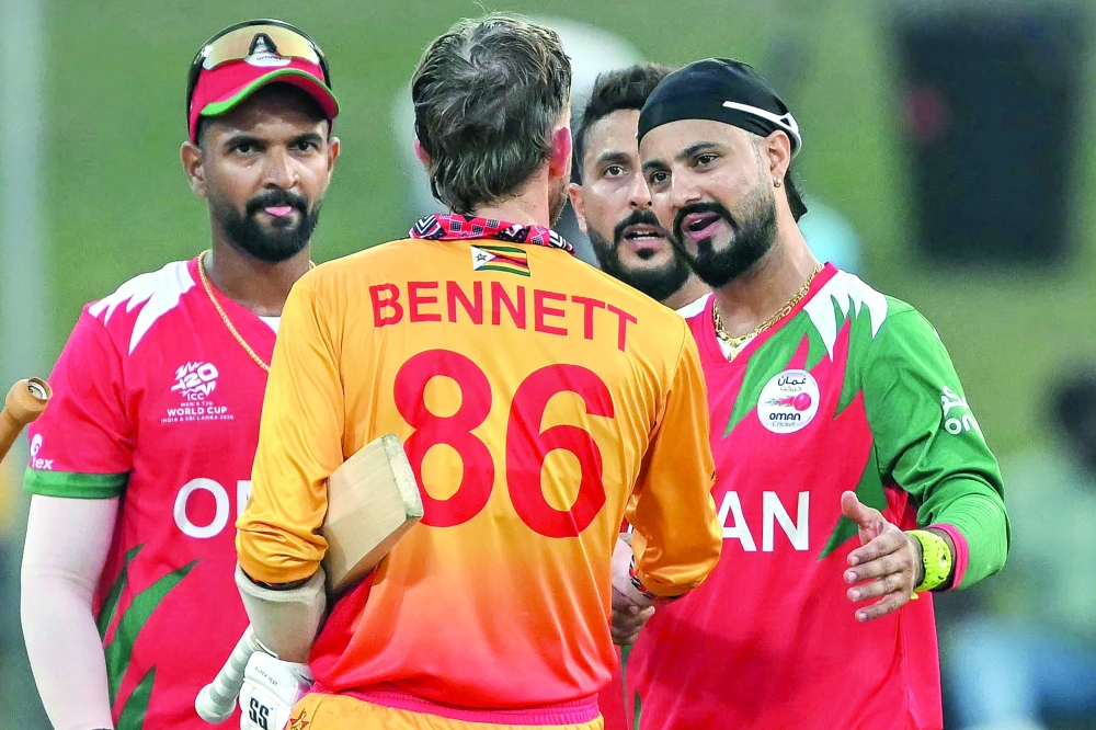 Oman's captain Jatinder Singh (R) shakes hands with Zimbabwe's Brian Bennett (C) at the end of the 2026 ICC Men's T20 Cricket World Cup group stage match between Zimbabwe and Oman at the Sinhalese Sports Club Ground in Colombo on February 9, 2026.  (Photo by Ishara S. KODIKARA / AFP)
