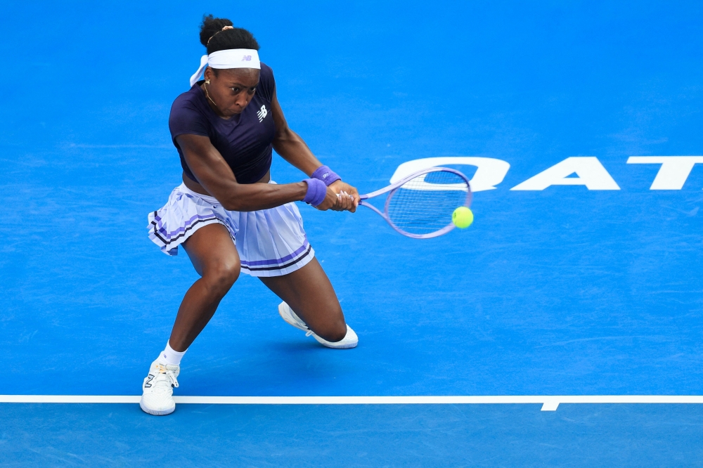 US' Coco Gauff hits a return against Italy's Elisabetta Cocciaretto  