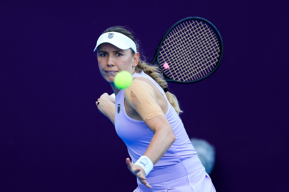 Russia痴 Ekaterina Alexandrova hits a return against Latvia's Jelena Ostapenko 