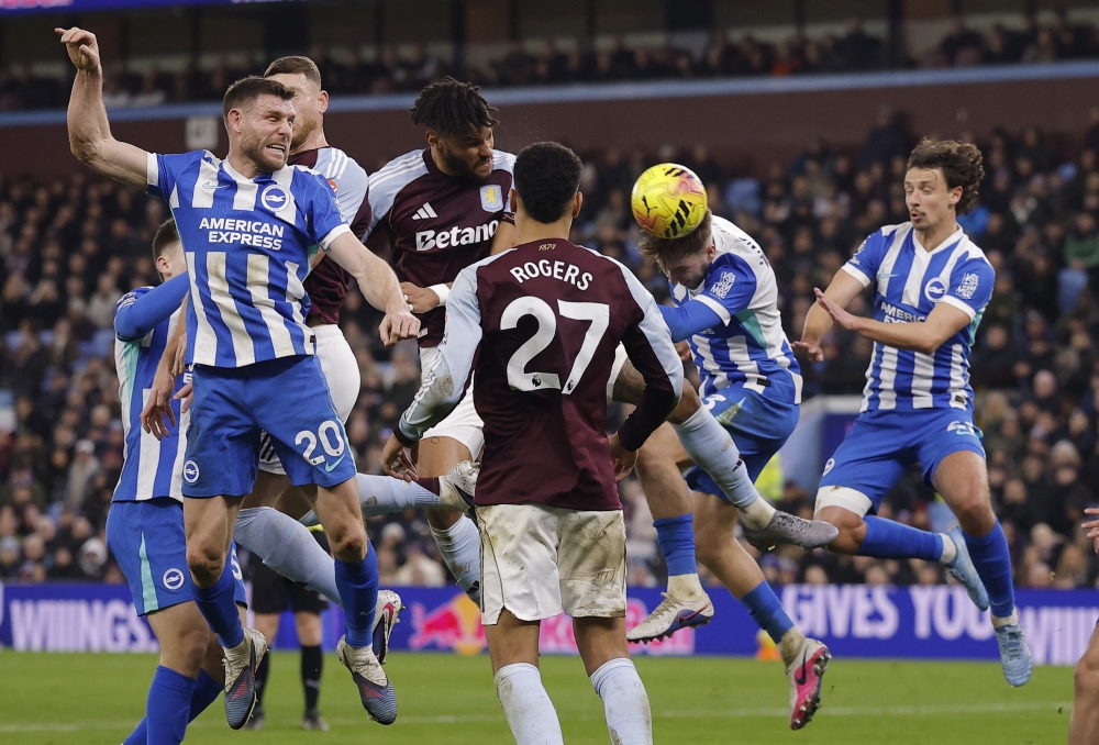   Aston Villa's Tyrone  heads at goal before Brighton & Hove Albion's Jack scores an own goal and the first for Aston Villa  