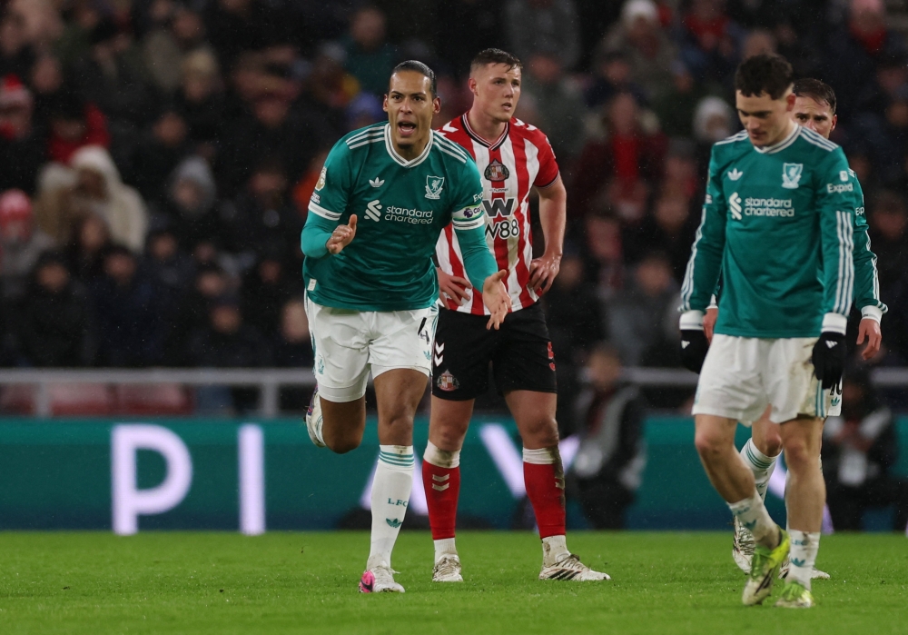   Liverpool's Virgil van Dijk celebrates scoring their first goal  