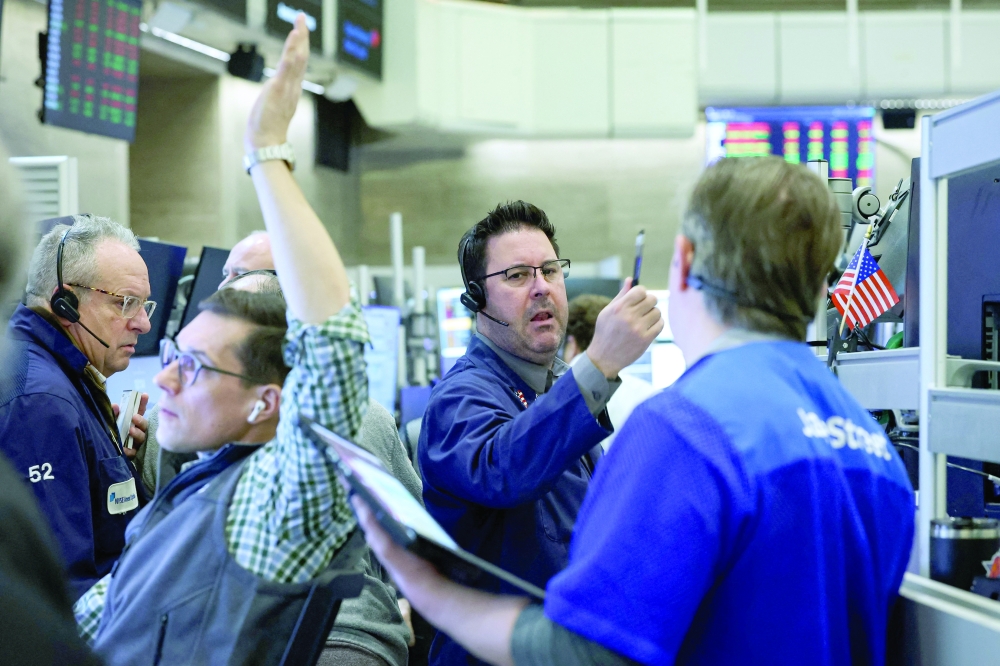 Traders work on the floor of the NYSE in New York