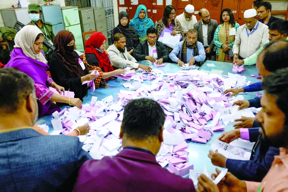 Electoral workers sort the ballots before counting the votes during the 13th general election in Dhaka. - Reuters