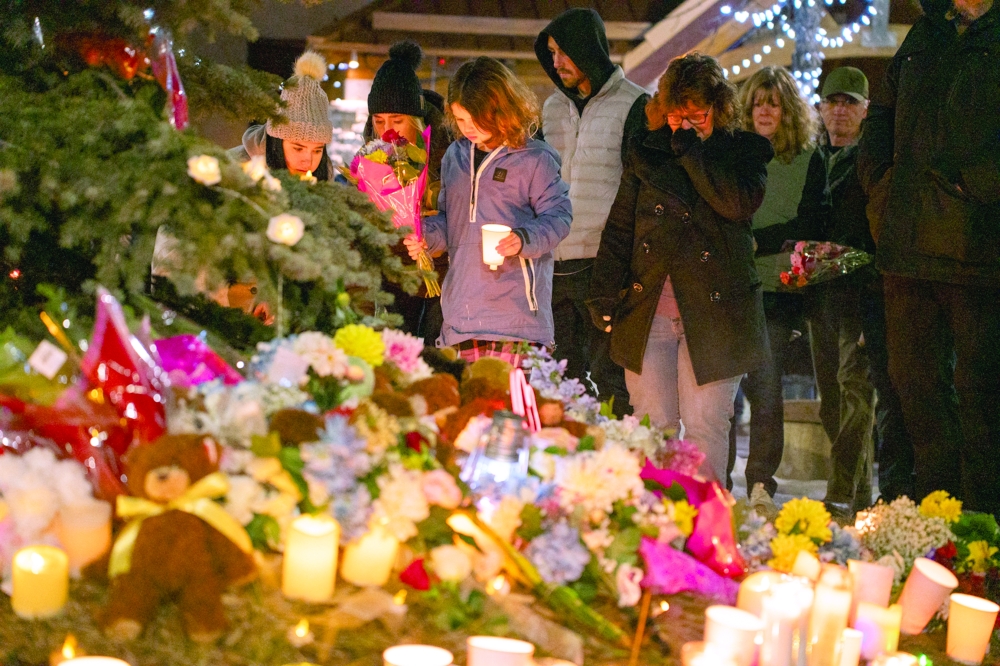 Community members mourn during a candlelight vigil for the victims of Tumbler Ridge Secondary School where a mass shooting took place a day earlier in the small town of Tumbler Ridge, British Columbia. — AFP
