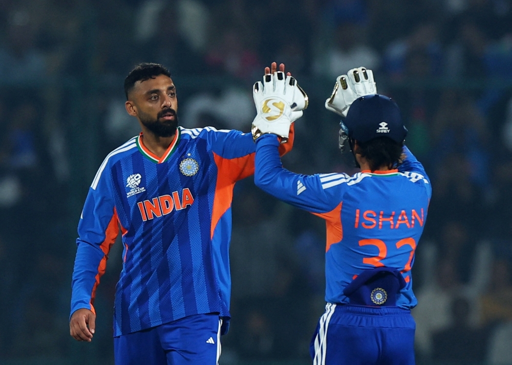  India's Varun Chakravarthy celebrates with Ishan Kishan 