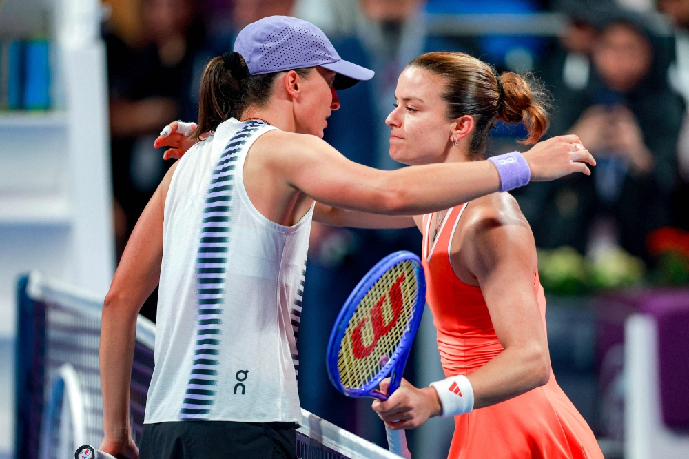 Greece's Maria Sakkari (R) is congratulated by Poland's Iga Swiatek