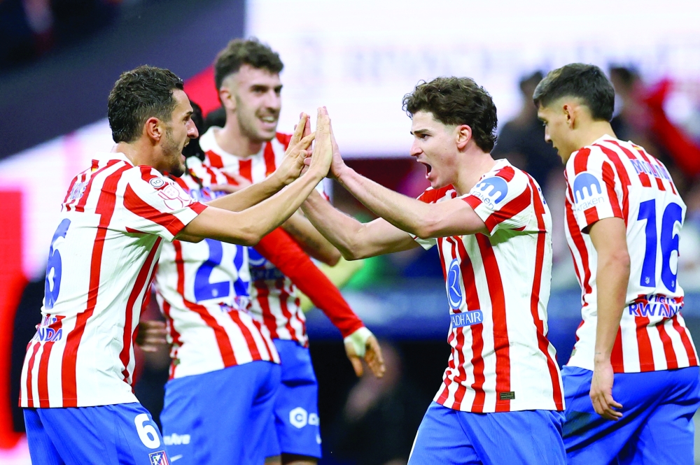 Atletico Madrid's Julian Alvarez celebrates scoring their fourth goal with teammates