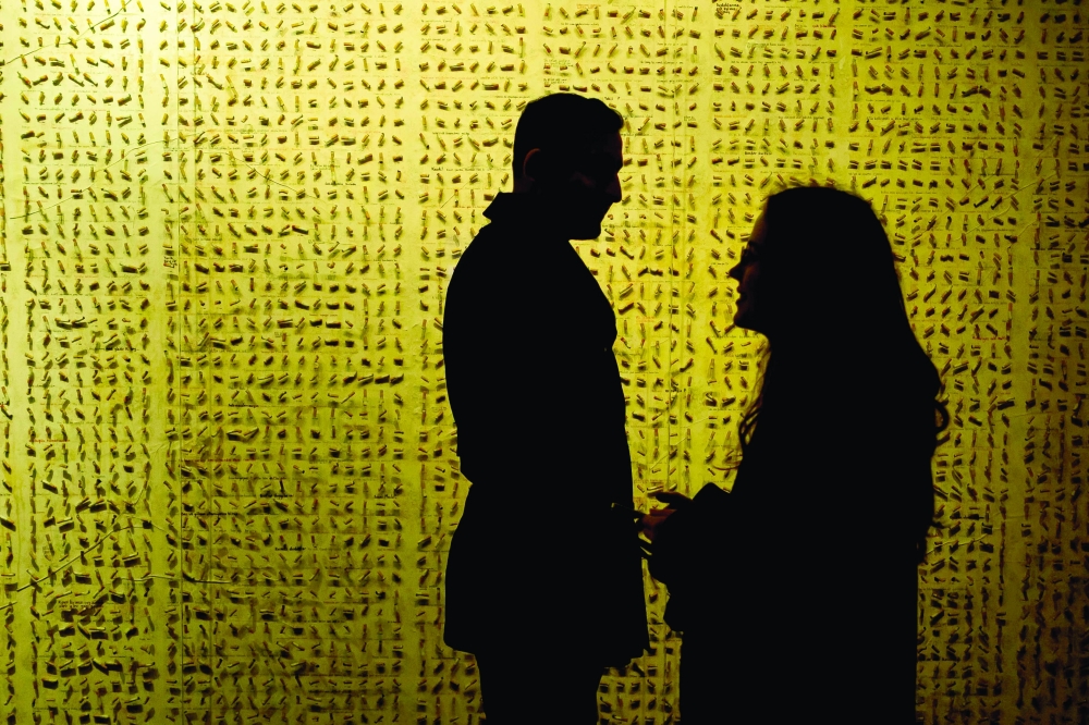 Visitors stand in front of a wall in The Museum of Innocence in Istanbul. On a cobbled street in Cukurcuma, a district known for its antiques shops on Istanbul's European side, the story penned by Nobel Literature Prize-winning Turkish author Orhan Pamuk has been brought to life inside the walls of a red-painted house