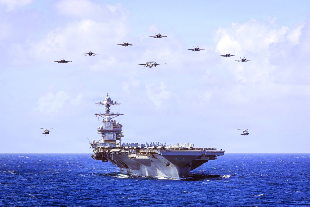 USS Gerald R Ford and its escort ships will join that strike group after officials ordered it to the Middle East from its current deployment in the Caribbean Sea.