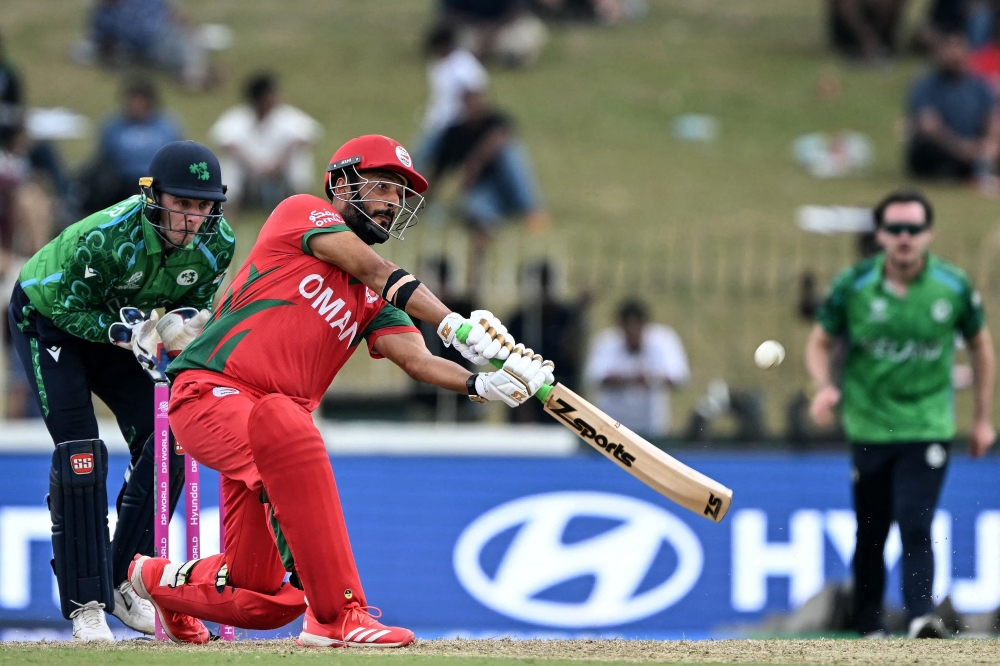 Oman's Sufyan Mehmood (R) plays a shot during the 2026 ICC Men's T20 Cricket World Cup  
