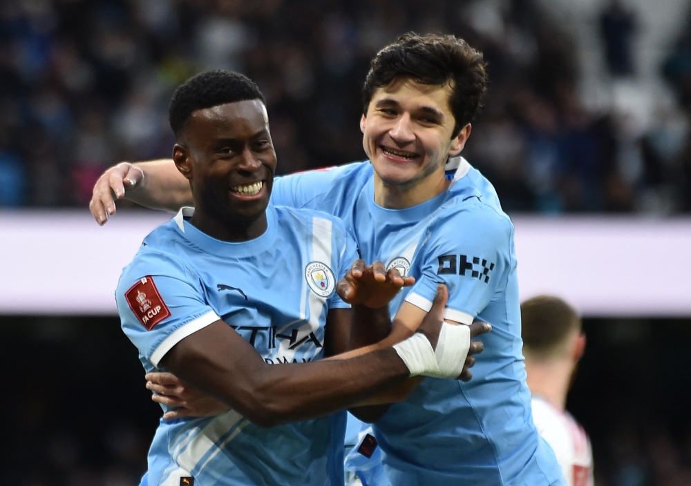  Manchester City's Marc celebrates scoring their second goal with Abdukodir
