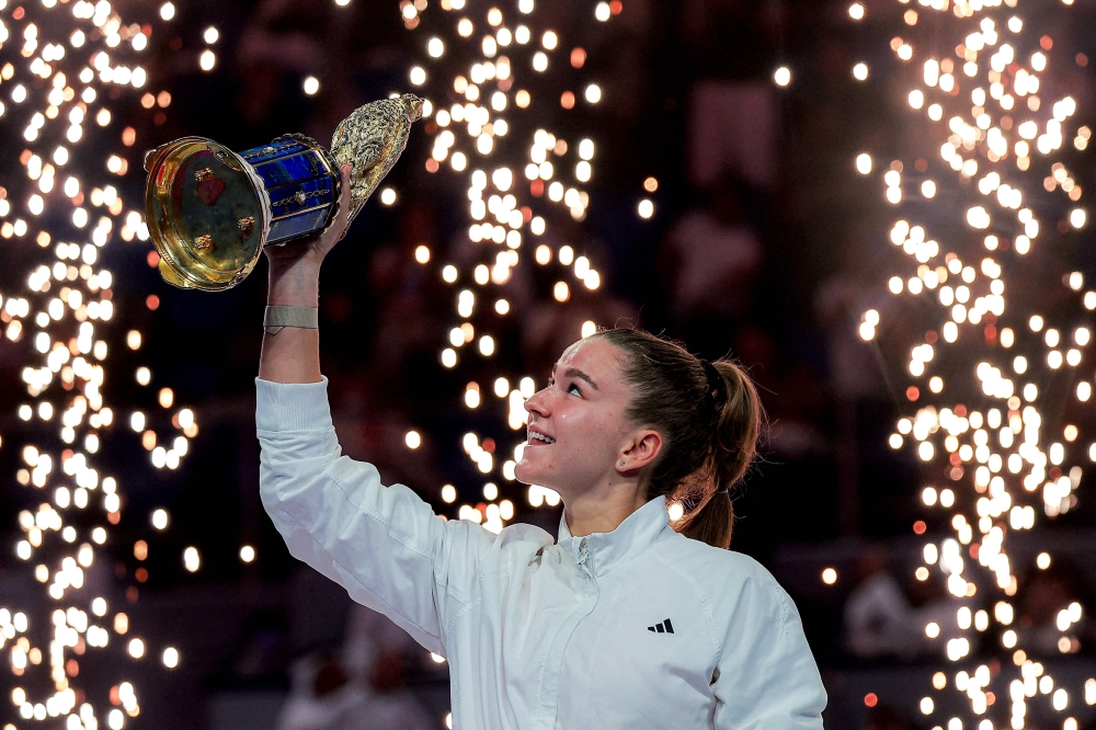 Czech Republic's Karolina Muchova reacts as she holds up the winner's trophy 