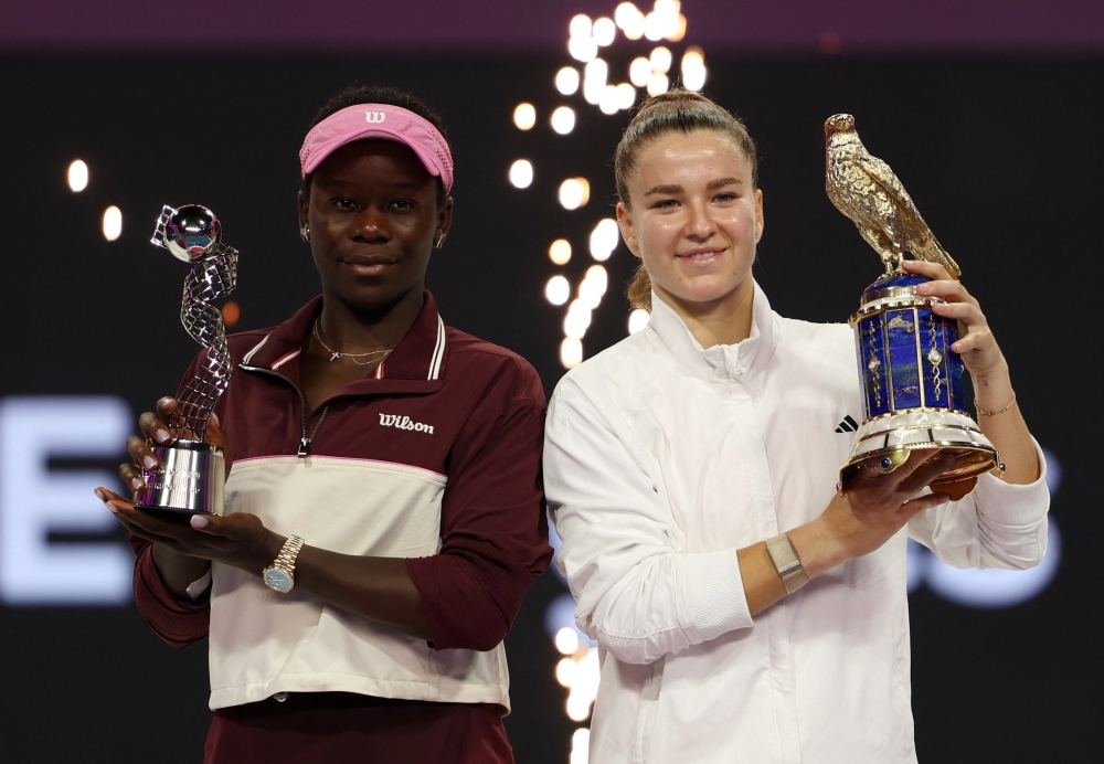   Czech Republic's Karolina Muchova poses with her winners trophy alongside runner up Canada's Victoria Mboko  