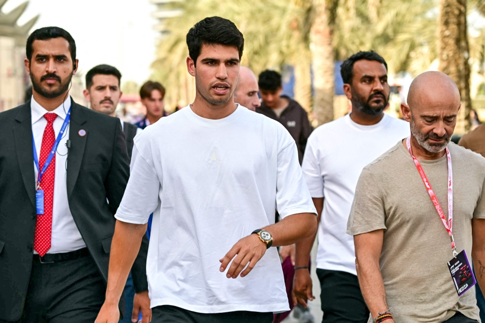   Alcaraz (C) visits the track on the second day of the Formula One pre-season testing at Bahrain  