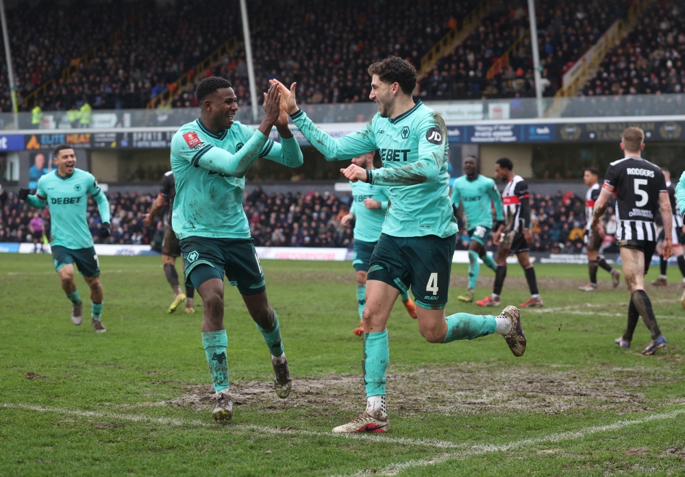  Wolverhampton Wanderers' Santiago Bueno celebrates scoring their first goal with teammates  