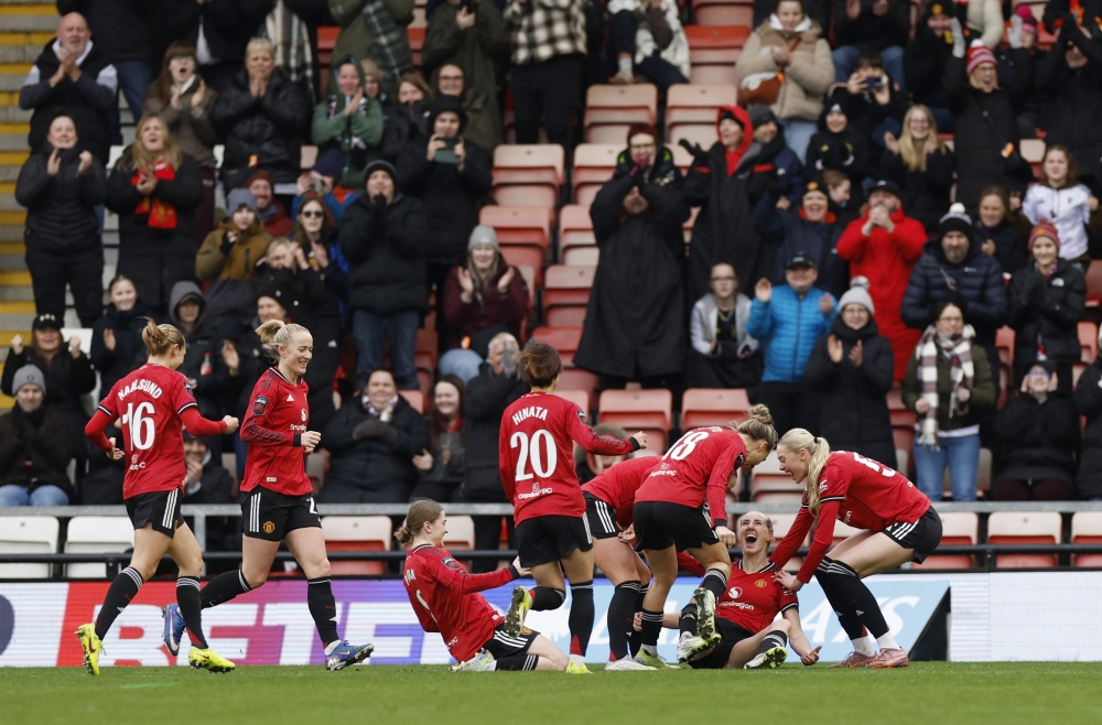   Manchester United's Millie Turner celebrates scoring their second goal with teammates  