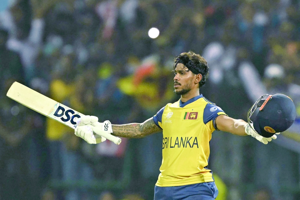 Sri Lanka's Pathum Nissanka celebrates after scoring a century (100 runs) during the 2026 ICC Men's T20 Cricket World Cup group stage match between Australia and Sri Lanka at Pallekele International Cricket Stadium in Kandy on February 16, 2026. (Photo by Ishara S. KODIKARA / AFP)
