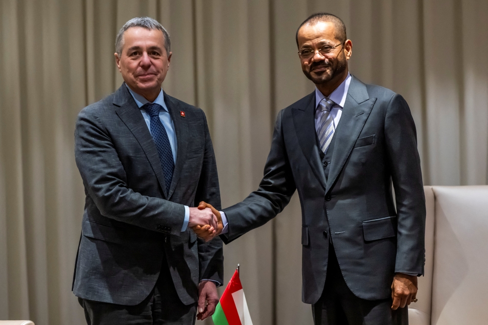 Switzerland's Foreign Minister and Federal Councillor Ignazio Cassis shakes hands with Omani Foreign Minister Sayyid Badr Hamad Al Busaidi during a bilateral meeting between Switzerland and Oman, in Geneva, Switzerland, February 16, 2026. 