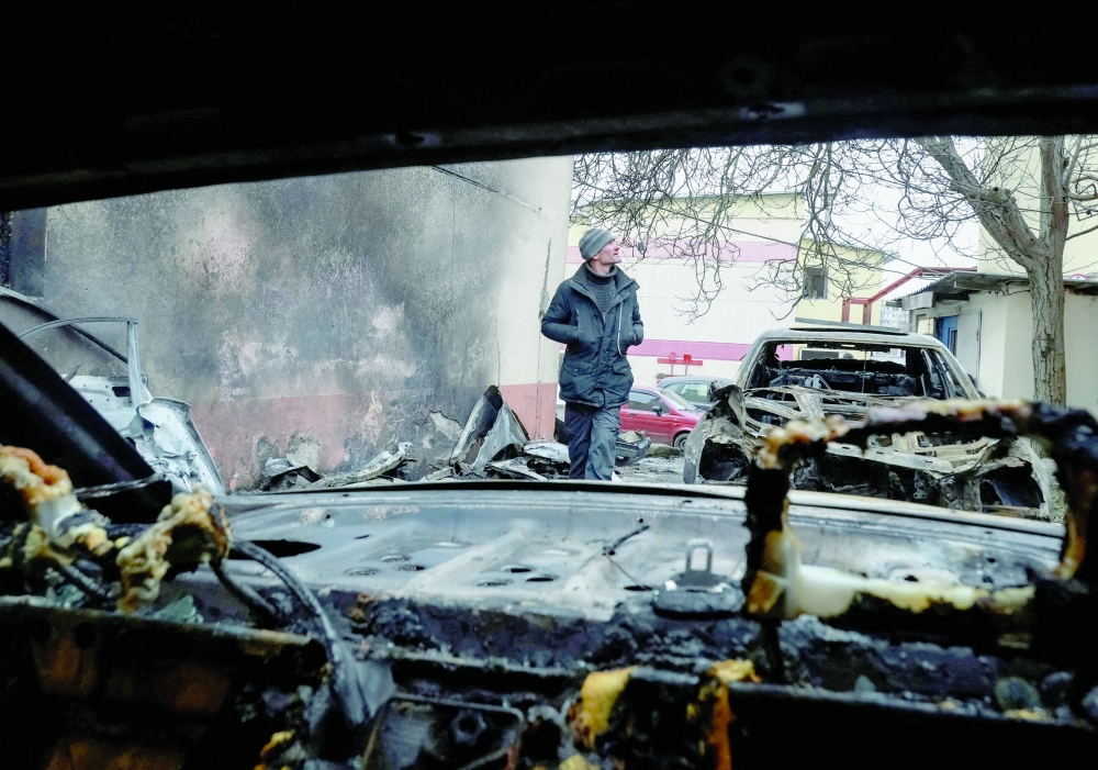 A resident walks near damaged cars at the site of a Russian drone strike, in Odesa, Ukraine. — Reuters