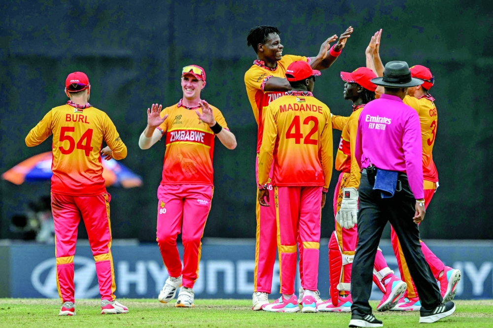 Zimbabwe's Blessing Muzarabani (C) celebrates with teammates after taking the wicket of Australia's Matt Renshaw during the 2026 ICC Men's T20 Cricket World Cup group stage match between Australia and Zimbabwe at the R Premadasa Stadium in Colombo on February 13, 2026.  (Photo by Ishara S. KODIKARA / AFP)
