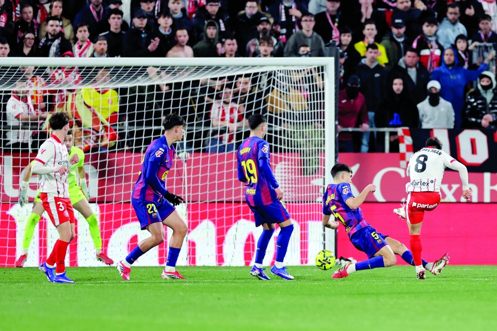 Girona's Spanish midfielder #08 Fran Beltran scores his team's second goal during the Spanish league football match between Girona FC and FC Barcelona at Montilivi Stadium in Girona on February 16, 2026. (Photo by Josep LAGO / AFP)
