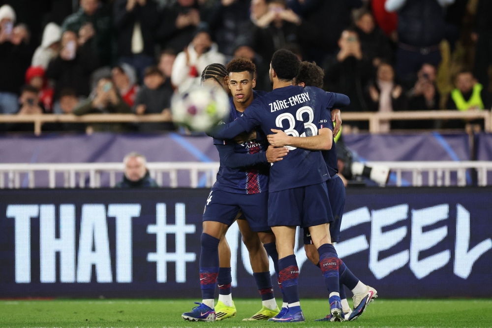 Paris Saint-Germain's French midfielder #14 Desire Doue (L) celebrates with teammates after scoring his team's third goal
  