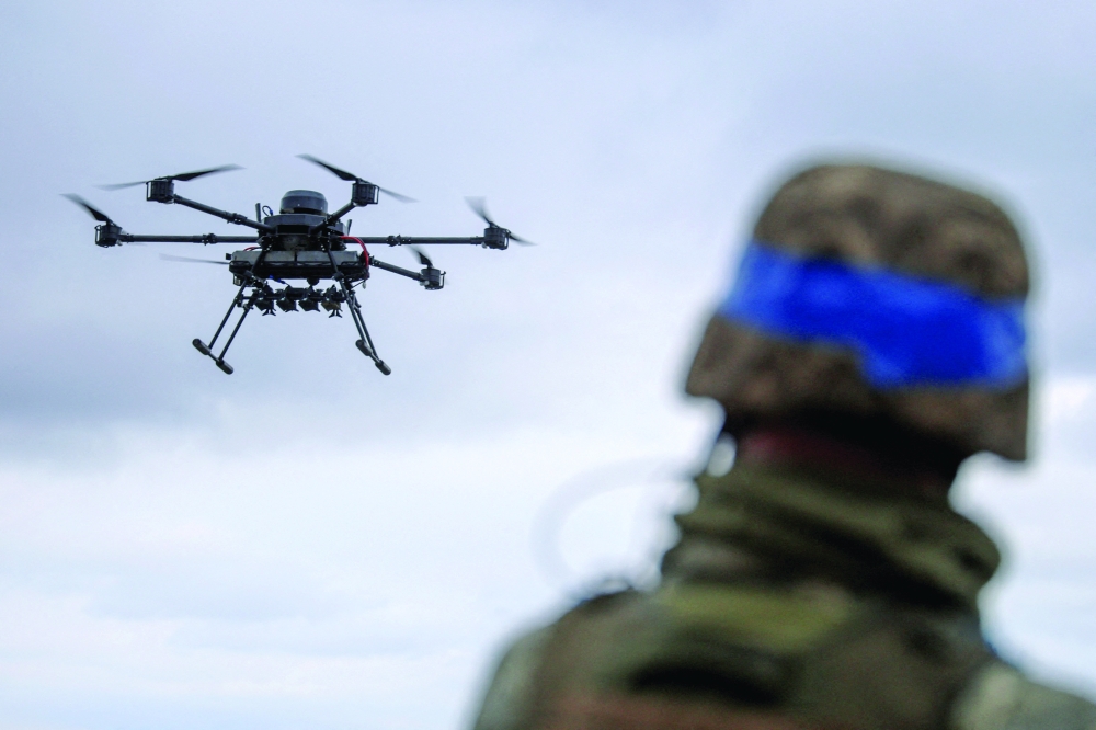 A Ukrainian serviceman of the 25th Airborne Brigade looks at a Vampire, a heavy unmanned aerial vehicle, during its flight near a front line in Donetsk region 