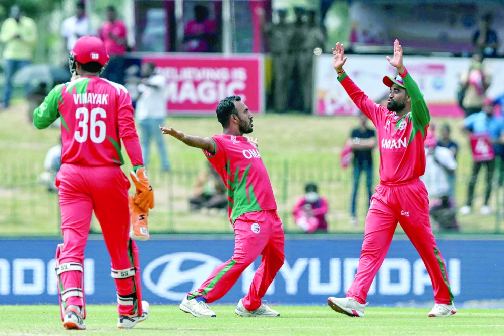 Oman's Shakeel Ahmed (C) celebrates with teammates after taking the wicket of Ireland's Harry Tector during the 2026 ICC Men's T20 Cricket World Cup group stage match between Ireland and Oman at the Sinhalese Sports Club Ground in Colombo