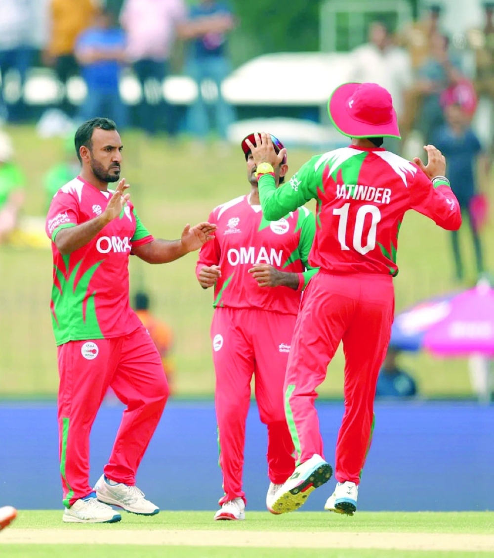Shakeel Ahmed celebrates with teammates after taking a wicket