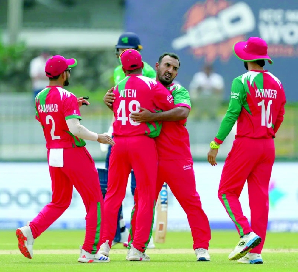 Shakeel Ahmed celebrates with teammates after taking a wicket against Ireland