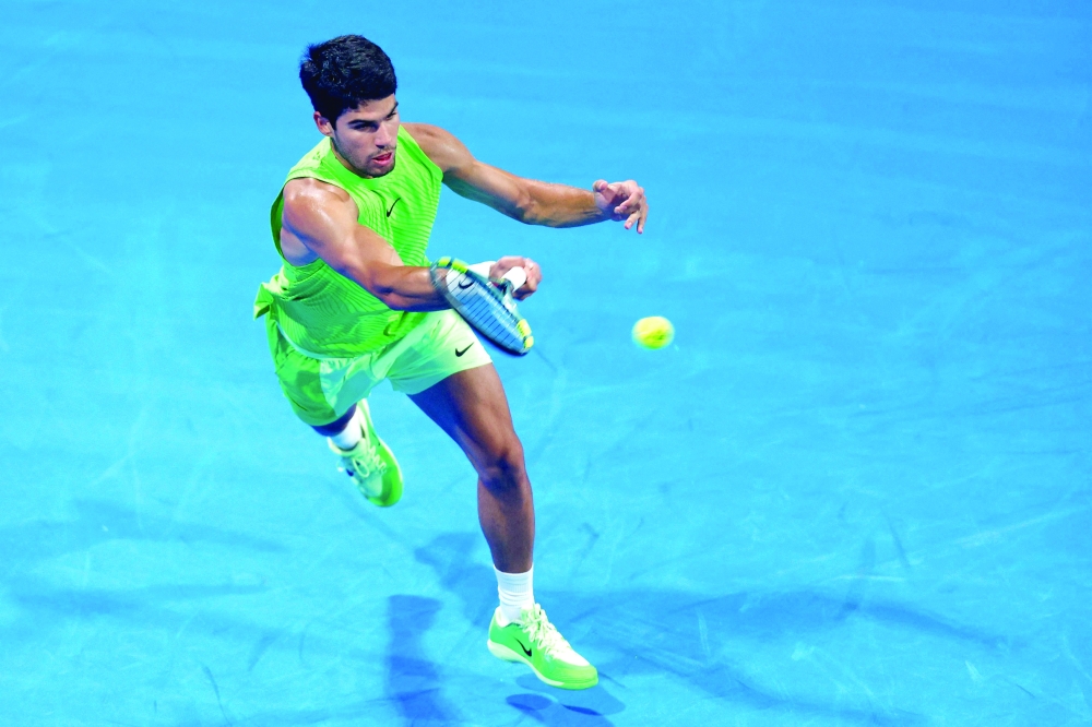 Spain's Carlos Alcaraz hits a return against France's Valentin Royer during their men's singles match at the Qatar Open tennis tournament in Doha on February 18, 2026. (Photo by Karim JAAFAR / AFP)
